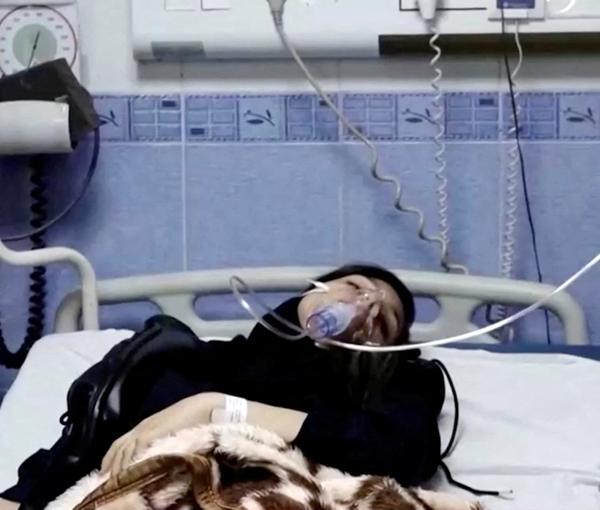 A young woman lies in hospital after reports of poisoning at an unspecified location in Iran in this still image from video from March 2, 2023.
