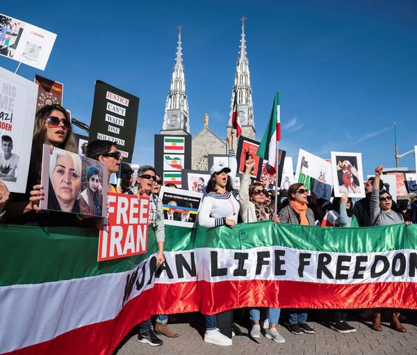 Protestors in support of women in Iran hold a banner reading 'Women Life Freedom' during a protest following the death of Mahsa Amini, in Ottawa, Ontario, Canada, October 29, 2022.