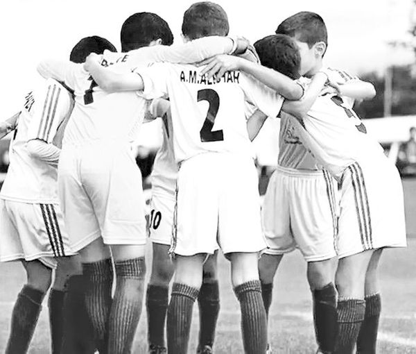 A number of teenage football players huddling before a match  (file photo)