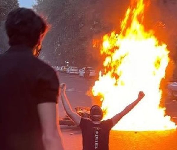 Protesters light a fire in a Tehran street in September 2022