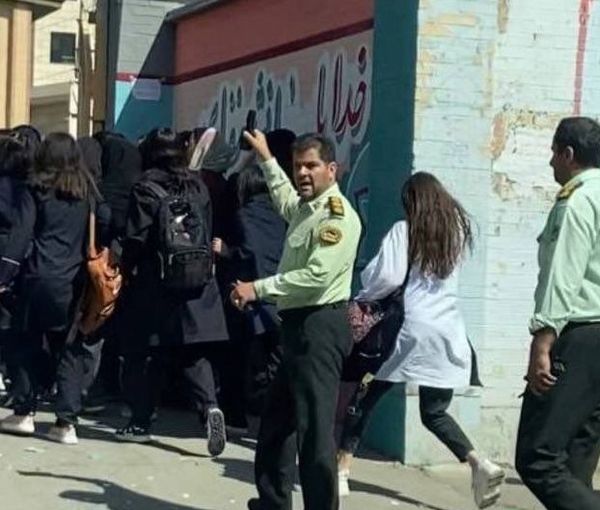 Police officers trying to control schoolgirls protesting against the Islamic Republic. Oct. 4, 2022