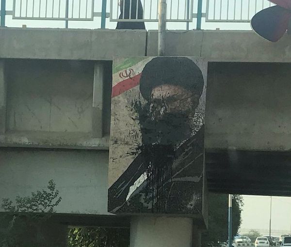 Protesters have thrown black paint at a large banner of Iran's ruler Ali Khamenei. Photo dated October 24, 2022