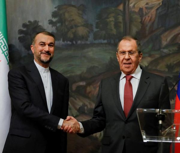 Russian Foreign Minister Sergei Lavrov shakes hands with Iranian Foreign Minister Hossein Amir-Abdollahian during a news conference following their meeting in Moscow, Russia March 29, 2023. 