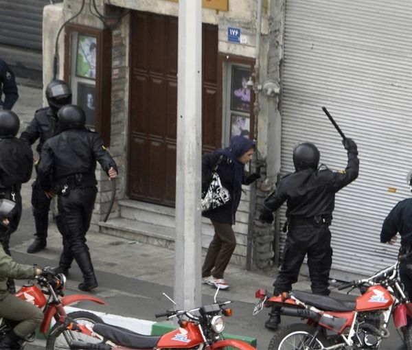 An undated photo showing special police units beating a woman in Iran