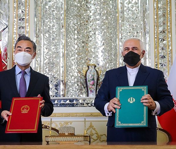 Iran’s former foreign minister Mohammad Javad Zarif (right) and China’s foreign minister Wang Yi during the signing ceremony of Iran-China strategic cooperation agreement in Tehran on March 27, 2021