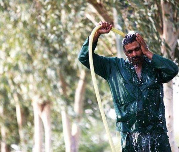 A worker cooling himself down in hot weather (file photo)