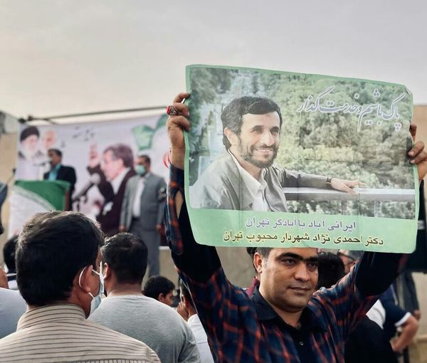 Supporters of Mahmoud Ahmadinejad with his posters in May 2021