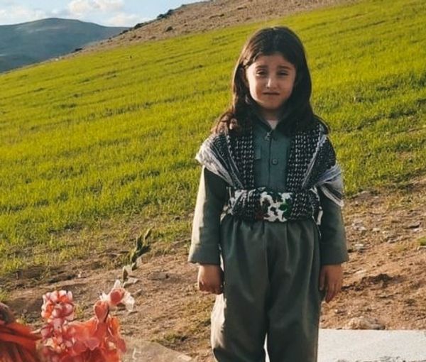 Little Kurdish girl standing at her mother’s grave on Nowruz in Mahabad. March 2023