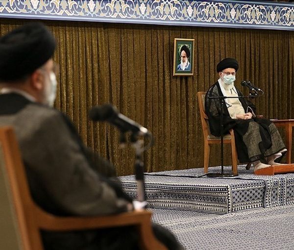 President Ebrahim Raisi listens to Supreme Leader Ali Khamenei during a ceremony. Undated