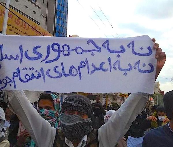 An Iranian holding a banner against the regime’s executions during a protest rally in the city of Zahedan (undated)