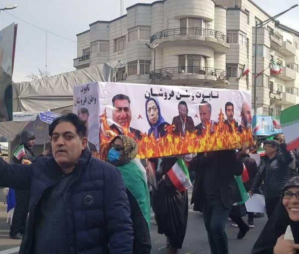 A poster showing opposition leaders burning, during a pro-government march in Tehran on Feb. 11, 2023