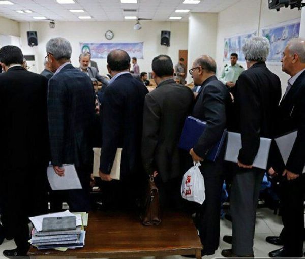 People stand in line inside a bank  (file photo)