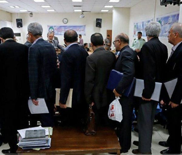 People stand in line inside a bank (file photo)