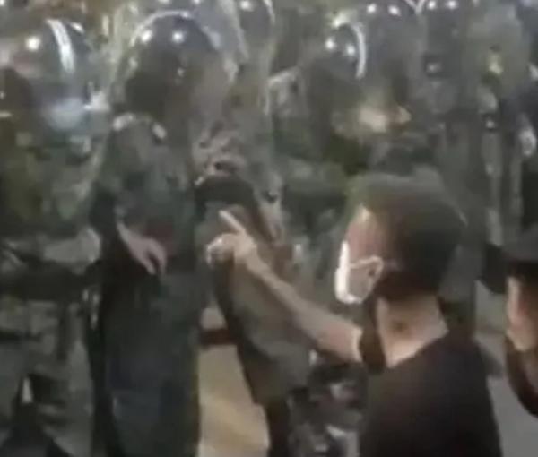 An Iranian protester confronting special police units trained to crush protests. May 2022