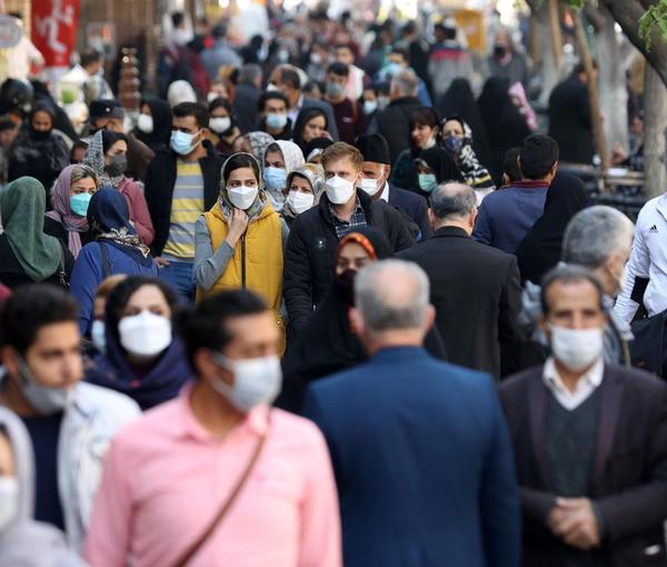 Crowds walk in a Tehran street on November 29, 2021.