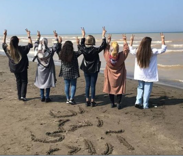 A group of Iranian women flashing victory sign to express support for the ‘Women, Life, Liberty; movement  