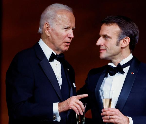 US President Joe Biden and France's President Emmanuel Macron making a toast, as the Bidens host the Macrons for a State Dinner at the White House, in Washington, December 1, 2022