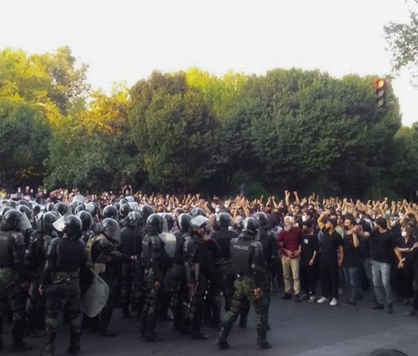 A large crowd of protesters in Tehran confronted by anti-riot forces, Sept. 19, 2022