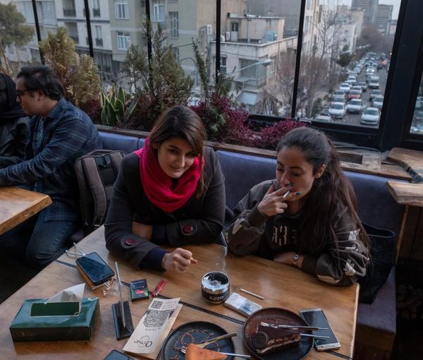 Iranian youths sit together at a cafe in downtown Tehran, January 29, 2023. 