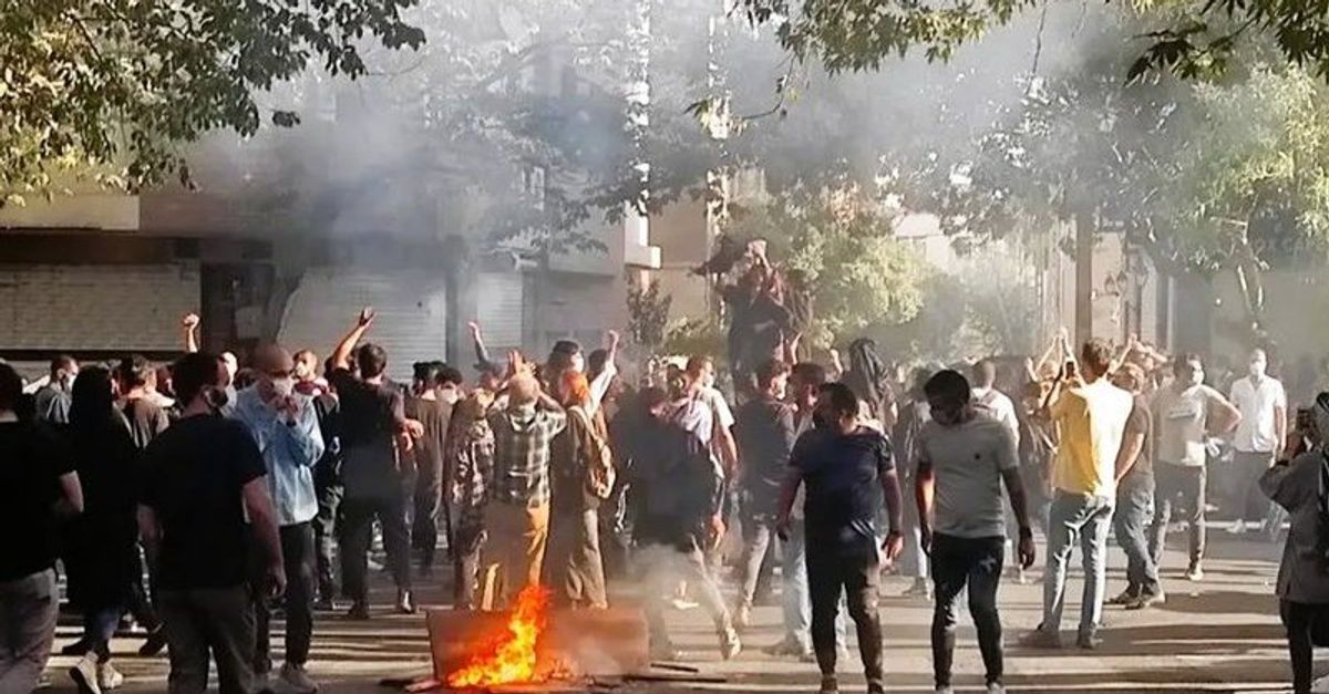 Protesters In Iran Chant, Set Fire To Regime’s Propaganda Banners