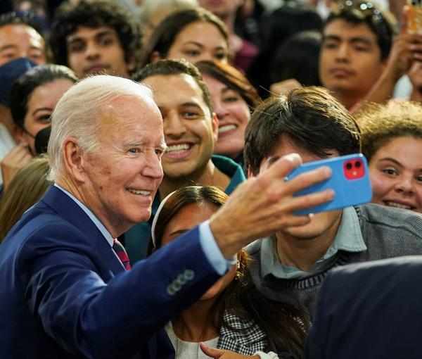President Joe Biden takes a selfie with supporters as he participates in a campaign fundraising event for Rep. Mike Levin (D-CA) in San Diego, November 3, 2022
