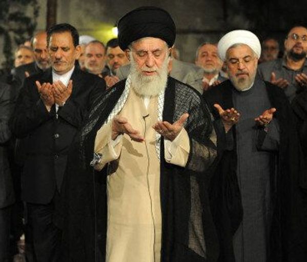 Iran’s ruler Ali Khamenei leading a prayer with reformist figures behind him (undated)
