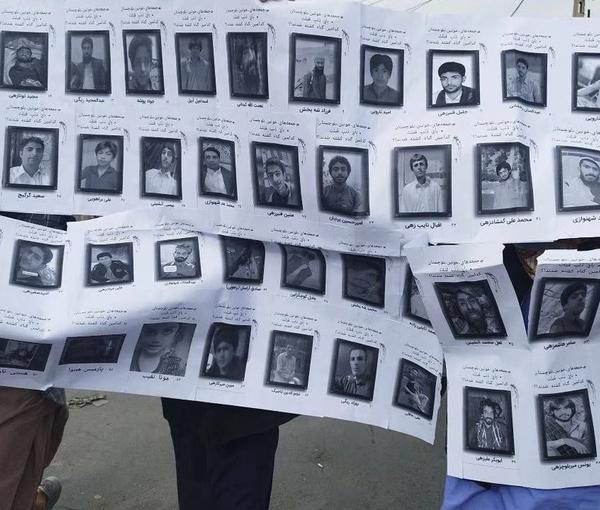 Demonstrators holding a banner with photos and names of some of Baluchis killed during the Islamic Republic’s crackdown on popular protests (undated)