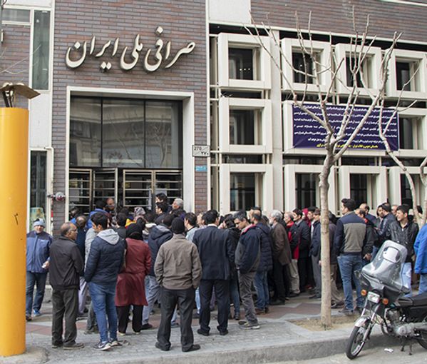 People gathered outside a bank foreign exchange office in Tehran. Undated