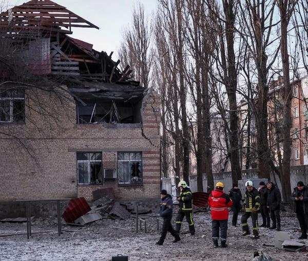 Rescuers and police officers examine parts of the drone at the site of a building destroyed by a Russian drone attack, as their attack on Ukraine continues, in Kyiv, December 14, 2022