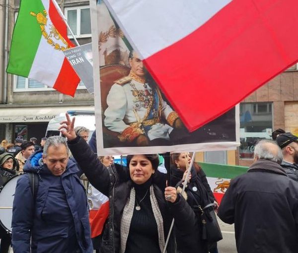 Protesters in Dusseldorf, Germany carrying a portrait of the late Shah Mohammad Reza Pahlavi on February 11, 2023