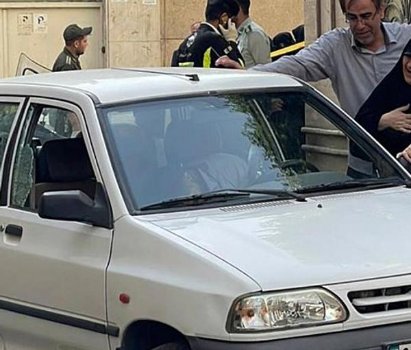 Family members of Colonel Hassan Sayyad-Khodayari, a member of the Quds Force of Iran’s Revolutionary Guards, cry over his dead body at his car outside his home on May 22, 2022.